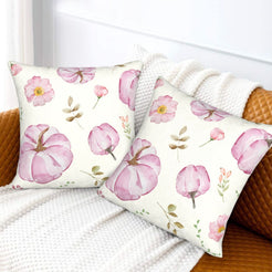 Autumn velvet pillow covers with cream pink pumpkins and flowers, styled on a sofa