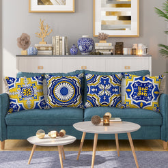 Water-resistant linen-look polyester pillow covers with yellow and blue Moroccan tile patterns, styled on a teal sofa