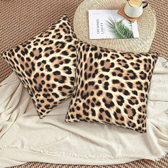Velvet pillow covers with tan classic leopard spots, styled on a beige sofa