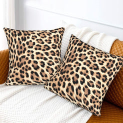 Velvet pillow covers with tan classic leopard spots, styled on a white sofa