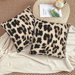Velvet pillow covers with cream oversized leopard spots, styled on a beige sofa