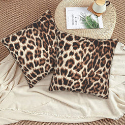 Velvet pillow covers with brown rosette leopard spots, styled on a beige sofa
