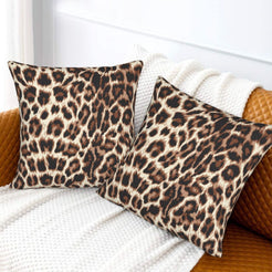 Velvet pillow covers with brown rosette leopard spots, styled on a white sofa