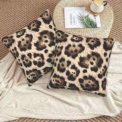 Velvet pillow covers with taupe abstract leopard spots, styled on a beige sofa