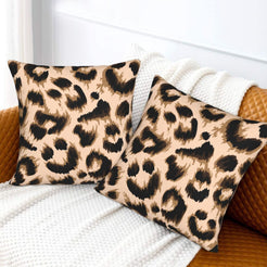Velvet pillow covers with blush brushstroke leopard spots, styled on a white sofa