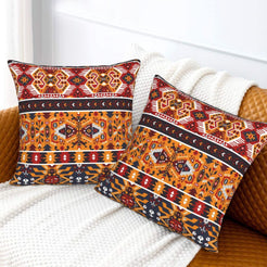 Bohemian velvet pillow covers with red and orange tribal diamonds, styled on a bed
