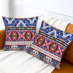 Bohemian velvet pillow covers with navy and coral Aztec medallions, styled on a bed