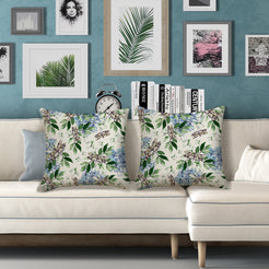 Outdoor water-resistant linen-look polyester pillow covers with birds and blue flowers, styled on a white sofa