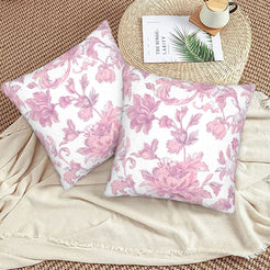 Pink toile velvet pillow covers with pink large peonies on white, styled on a woven chair