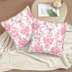 Pink toile velvet pillow covers with pink dense vintage florals on white, styled on a woven chair