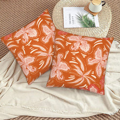 Bohemian floral velvet pillow covers with rust pink botanical pattern, styled on a woven chair