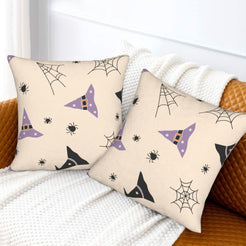 Halloween pillow covers with cream witch hats and spiderwebs, styled on a sofa