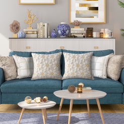 Quilted polyester pillow covers with raised cream pineapples, styled on a teal sofa