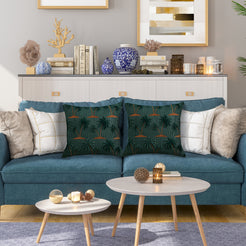 Quilted polyester pillow covers with raised palm trees on dark green, styled on a teal sofa