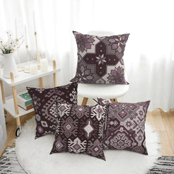 Bohemian short-pile plush pillow covers with gray and black Aztec motifs, styled on a floor cushion