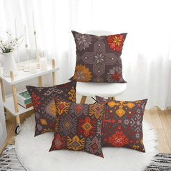 Bohemian short-pile plush pillow covers with charcoal and orange Aztec motifs, styled on a floor cushion