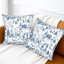 Blue on white winter holiday toile velvet pillow covers styled on a bed