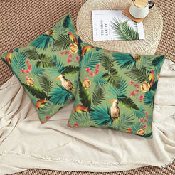 Tropical velvet pillow covers with sage palms and birds, styled on a woven chair