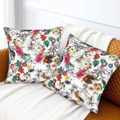 Tropical velvet pillow covers with white colorful birds and flowers, styled on a sofa