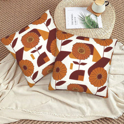 Fall velvet pillow covers with cream retro orange flowers and blocks, styled on a beige sofa