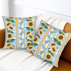 Velvet pillow covers with blue striped sunflowers, styled on a white sofa