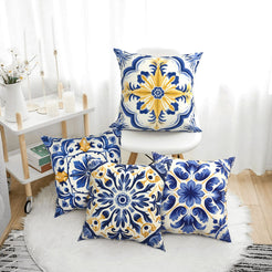 Short-pile plush pillow covers with blue, white and yellow tile medallions, styled in a bright room