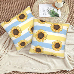 Velvet pillow covers with sunflowers on pale blue and yellow stripes, styled on a beige sofa
