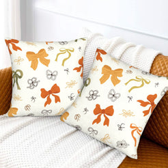Fall velvet pillow covers with scattered gingham bows, styled on a white sofa