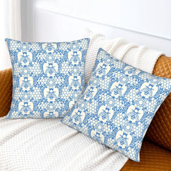 Velvet pillow covers with blue and white bees with floral lace pattern, styled on a white sofa