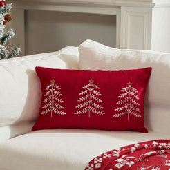 Red embroidered Christmas tree velvet lumbar pillow cover styled on a white sofa