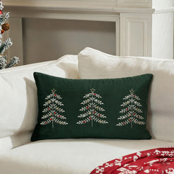 Green embroidered Christmas tree velvet lumbar pillow cover styled on a white sofa