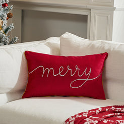 Red embroidered Merry velvet lumbar pillow cover styled on a white sofa