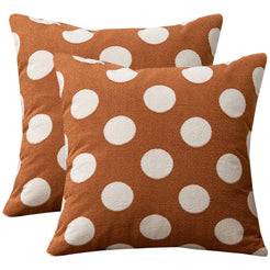 Set of two loop-pile textured polyester pillow covers with raised white polka dots on rust brown