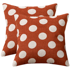 Set of two loop-pile textured polyester pillow covers with raised white polka dots on brick red