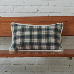 Ivory and navy tartan woven cotton-polyester blend lumbar pillow cover on a bed