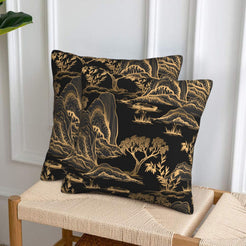 velvet polyester pillow covers with gold mountain and pagoda landscape on black, displayed on a woven chair