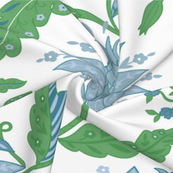 Fabric close-up of long lumbar pillow cover with blue and green scrolling floral vines