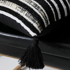 Corner tassel and striped chenille texture close-up in black and ivory