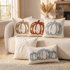 Tufted polyester pillow covers with outline pumpkins in rust, taupe, blue and cream, grouped on a cream sofa