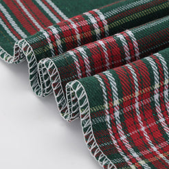 Green and red tartan woven polyester-cotton blend pillow covers, woven fabric edge close-up
