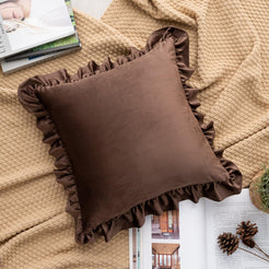 Chocolate brown velvet polyester pillow cover with ruffled edge, shown at an angle