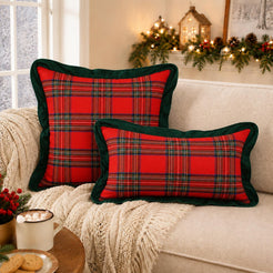 Square and lumbar polyester-cotton pillow covers with red and green tartan with dark green ruffle, styled on a sofa