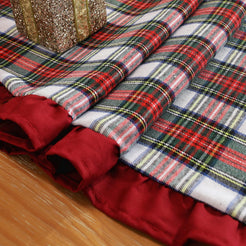 Fabric and ruffle close-up on polyester-cotton pillow cover with white, red and black tartan with burgundy ruffle