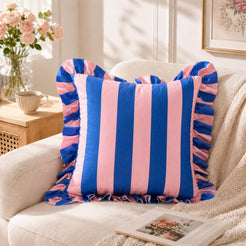 Pink and royal blue striped velvet polyester pillow covers with ruffled edges, styled as a single cover