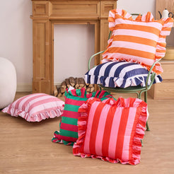 Pink and orange striped velvet polyester pillow covers with ruffled edges, arranged in a mixed-color display
