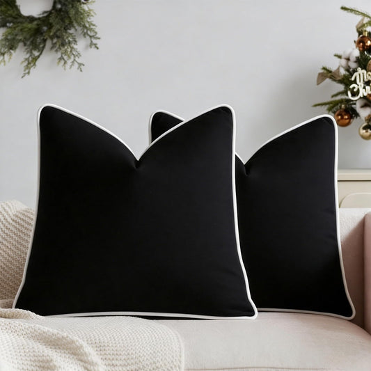 Set of two black velvet pillow covers with contrasting white piping