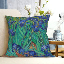 short-pile plush polyester pillow cover with blue irises with green leaves, shown on a cream sofa