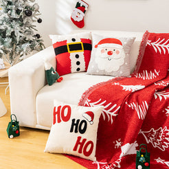 embroidered polyester canvas pillow covers with nutcracker, Santa and HO HO HO embroidery, styled on a white sofa