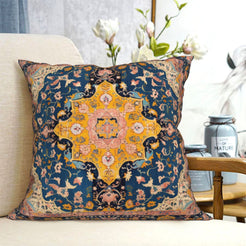 short-pile plush polyester pillow cover with ochre floral medallion on navy, shown on a cream sofa