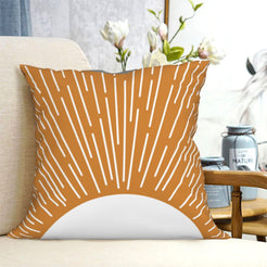 short-pile plush polyester pillow cover with orange sunburst rising over a white semicircle, shown on a cream sofa